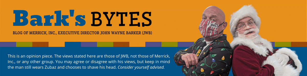 Executive Director JWB standing back to back with Santa