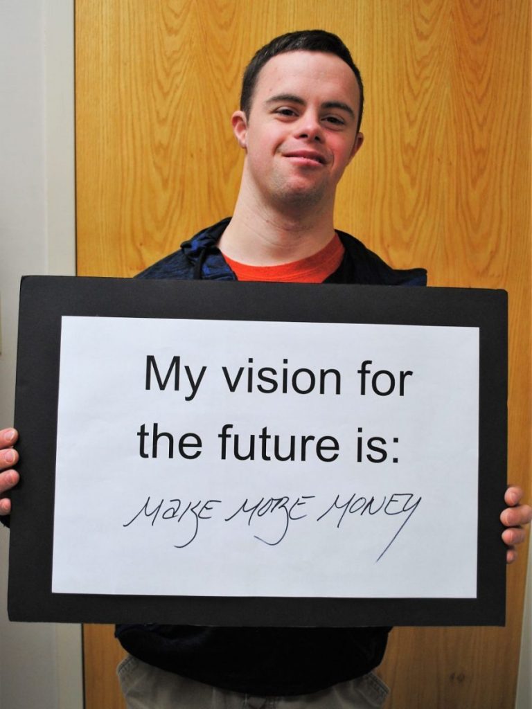 Client with vision statement poster