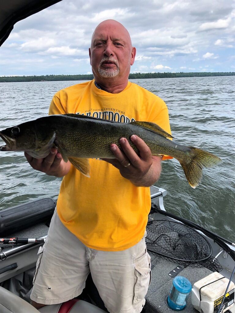John Wayne Barker with fish at lake
