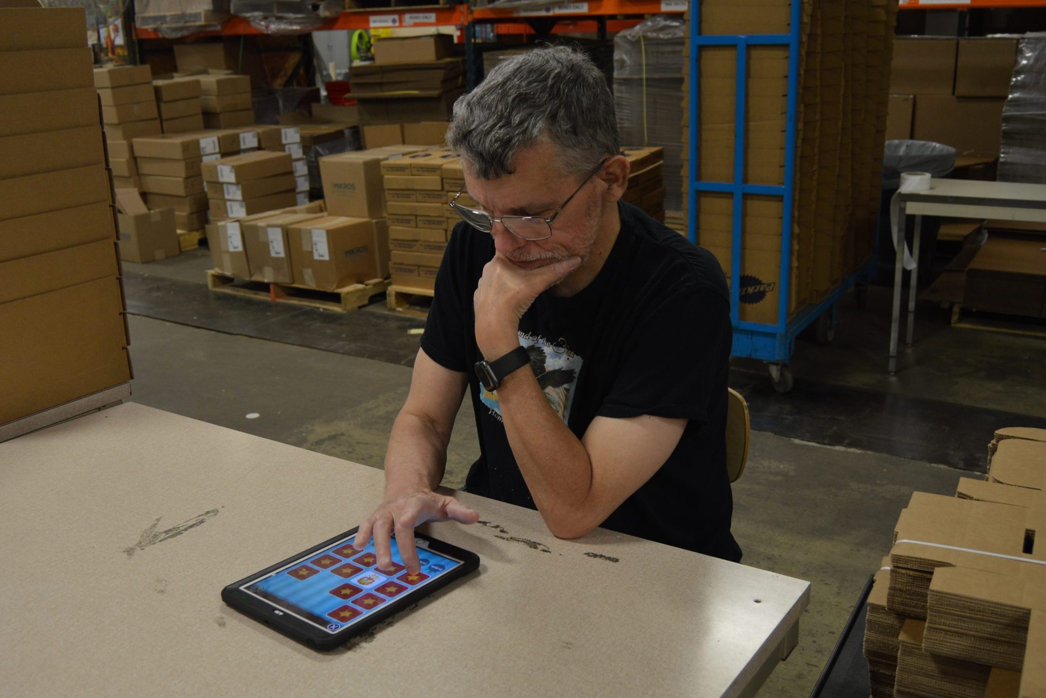 Male client playing games on tablet