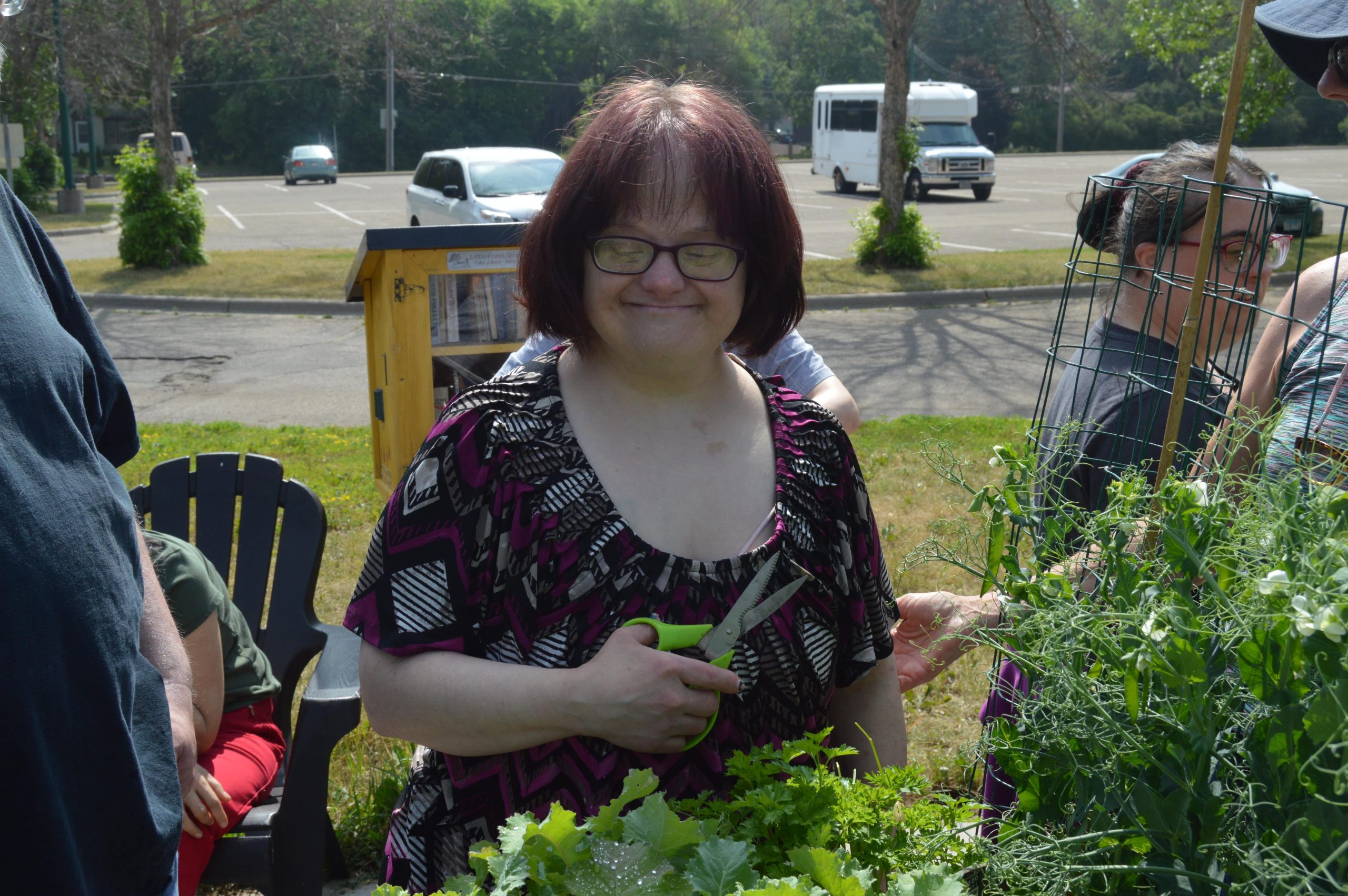 client harvesting greenbeans at community garden