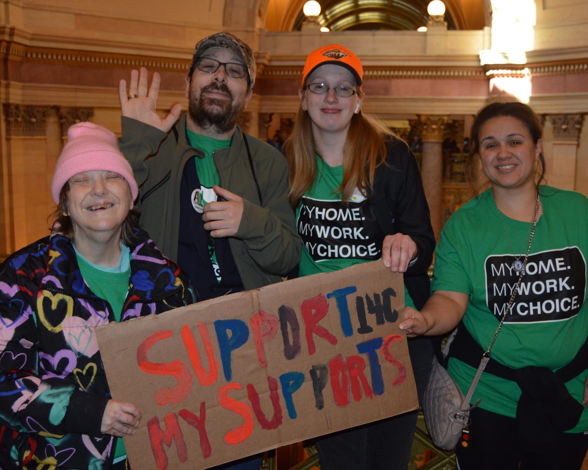 clients holding "support my supports" sign at capitol