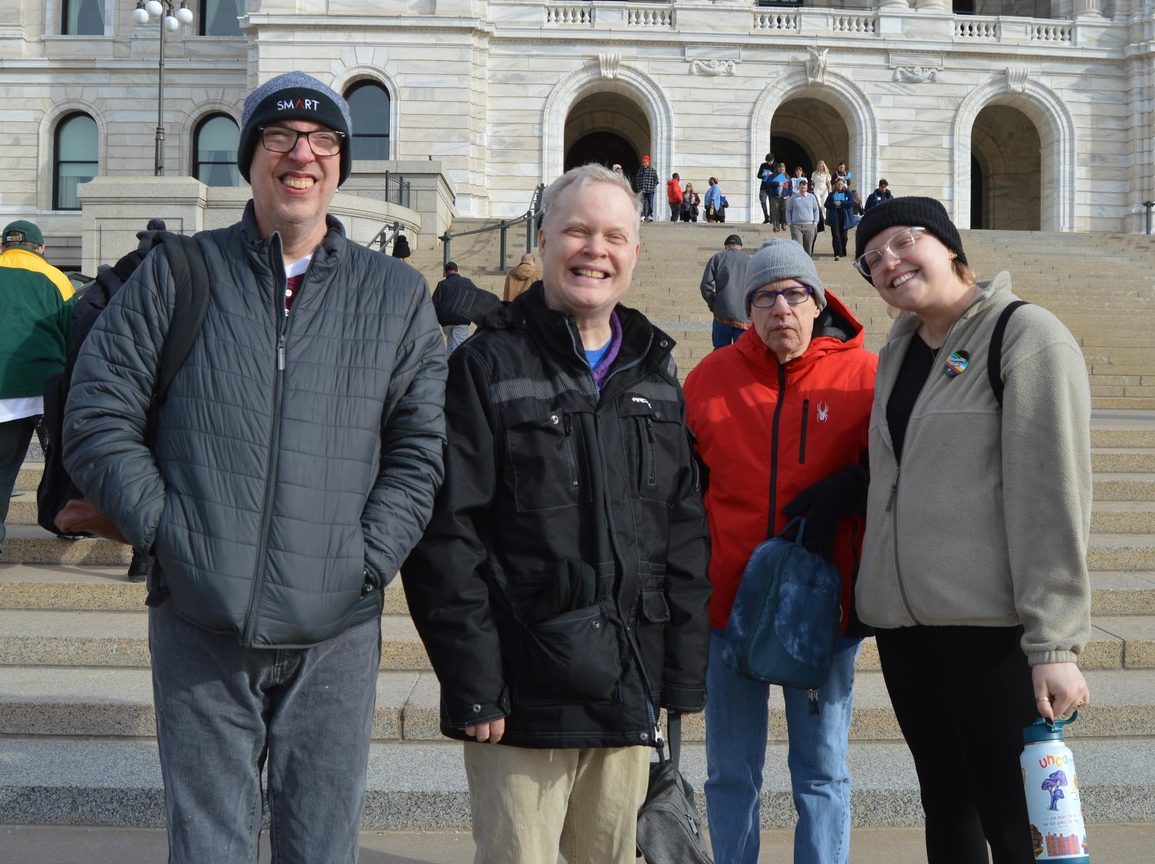 three clients and one staff on the front steps of the state capitol