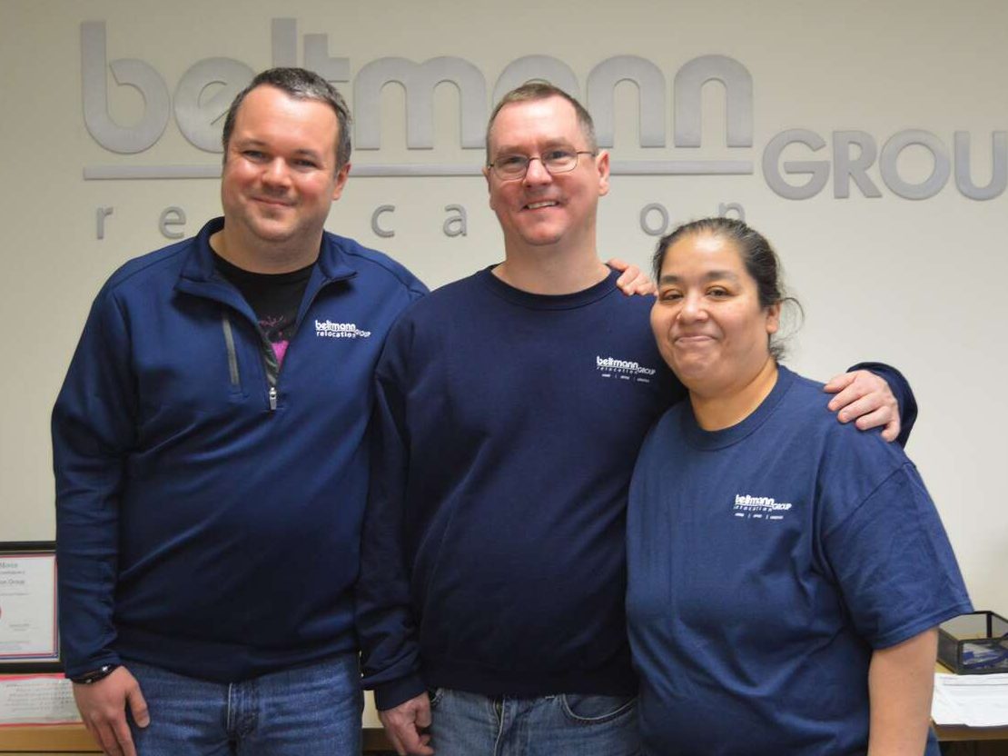 three direct hire clients in front of Beltmann Group wall decal