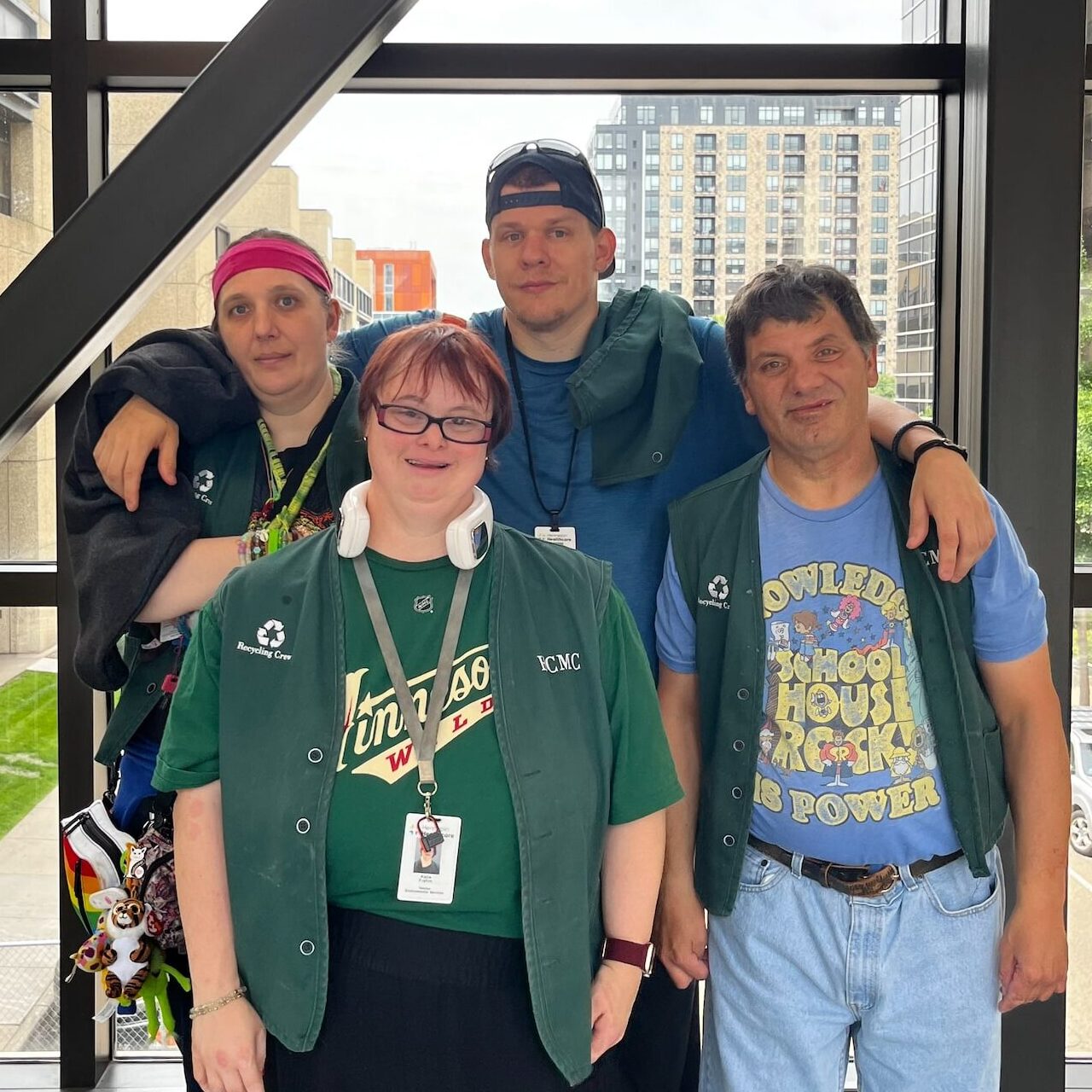 Four members of a recycling work crew pose together at Hennepin Healthcare.