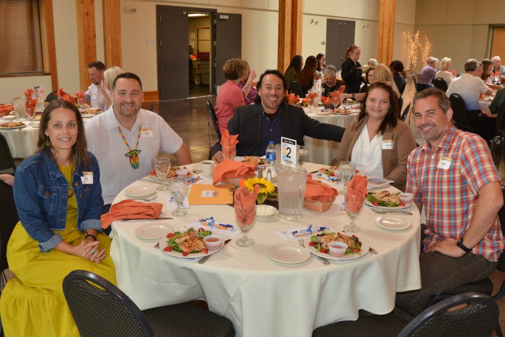 guests enjoying a delicious lunch seated around a festively decorated table