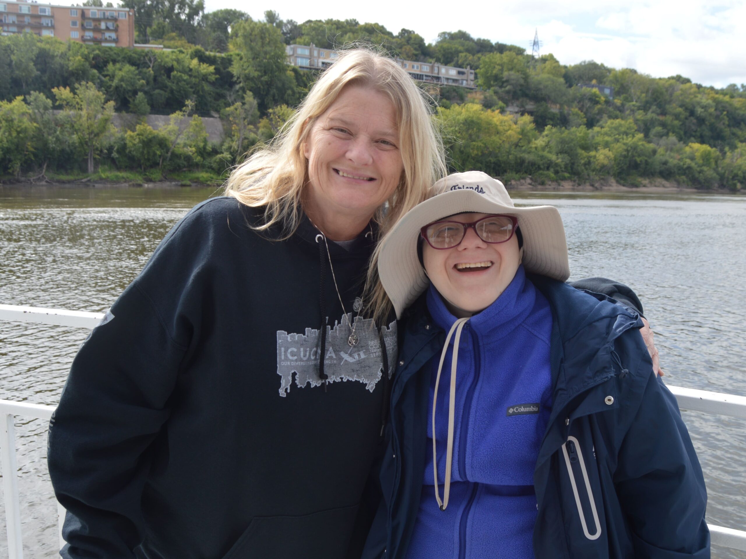 staff and client on river boat with Mississippi river in background