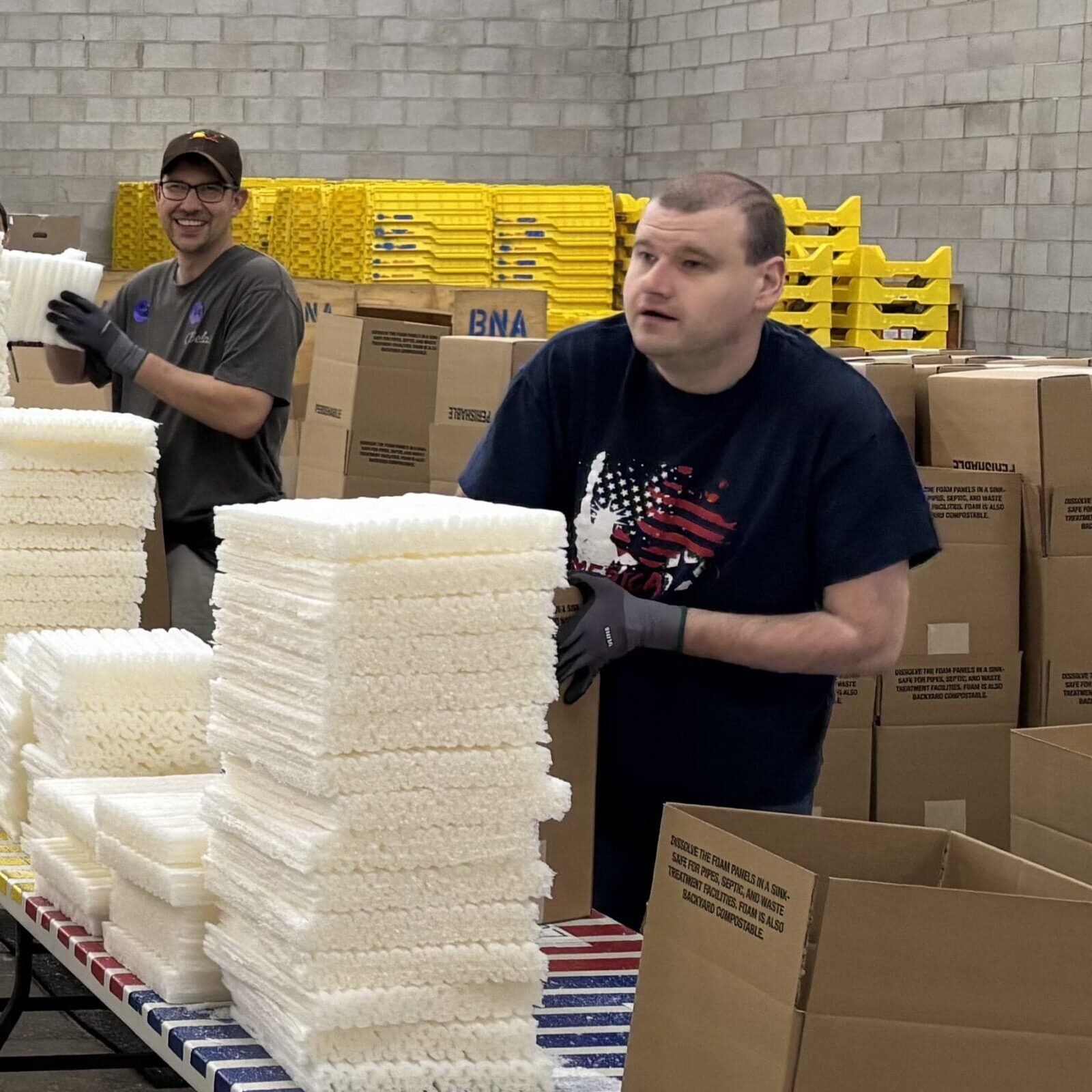 Employees assemble insulated coolers used to transport medications for Fairview Pharmacy.