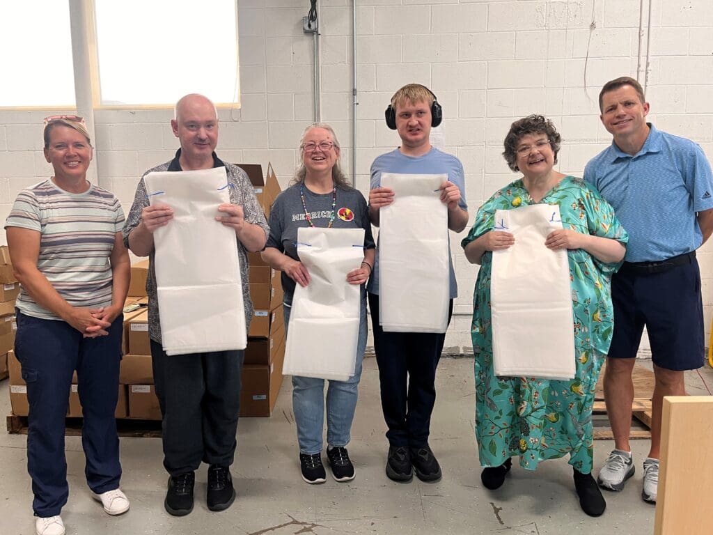 Individuals served holding up Ferlic Filter x-ray bags