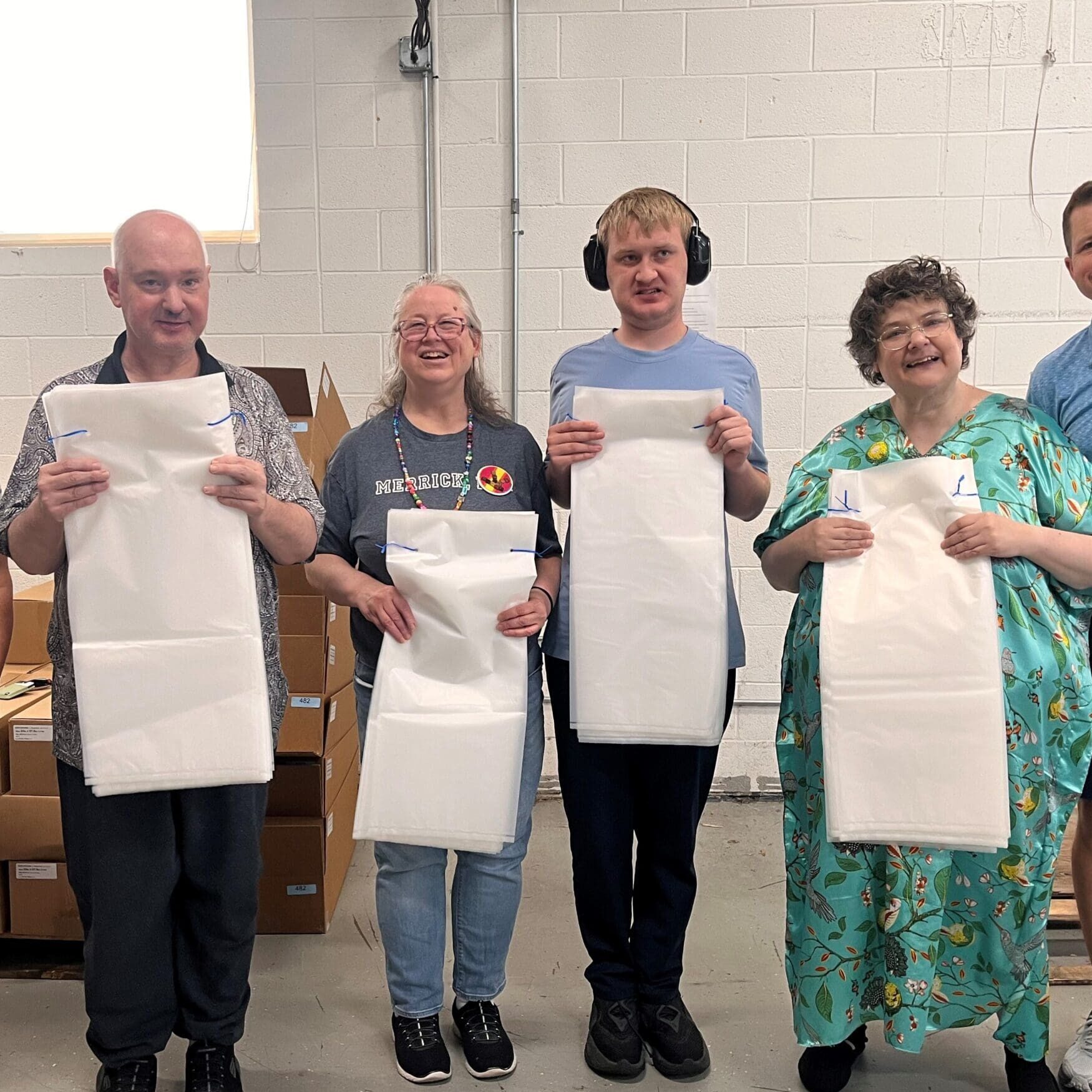 Four clients proudly holding up bundled Ferlic Filter x-ray bags.